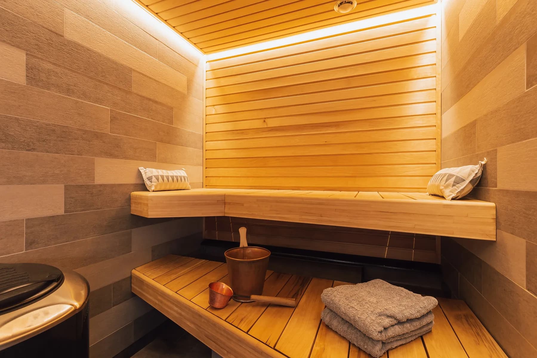 Timber sauna with an onyx niche and towel shelf