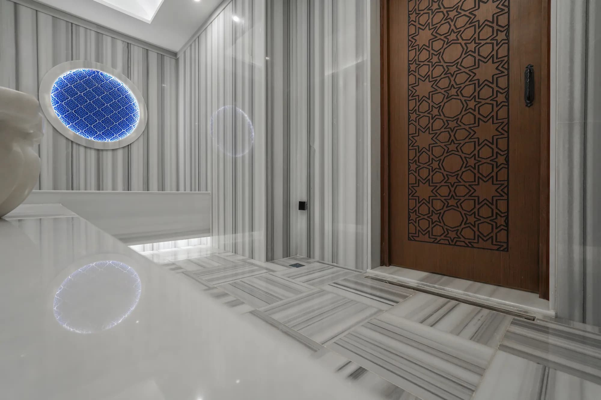 Hammam entrance with a carved door and marble floor, Istanbul (Turkey)