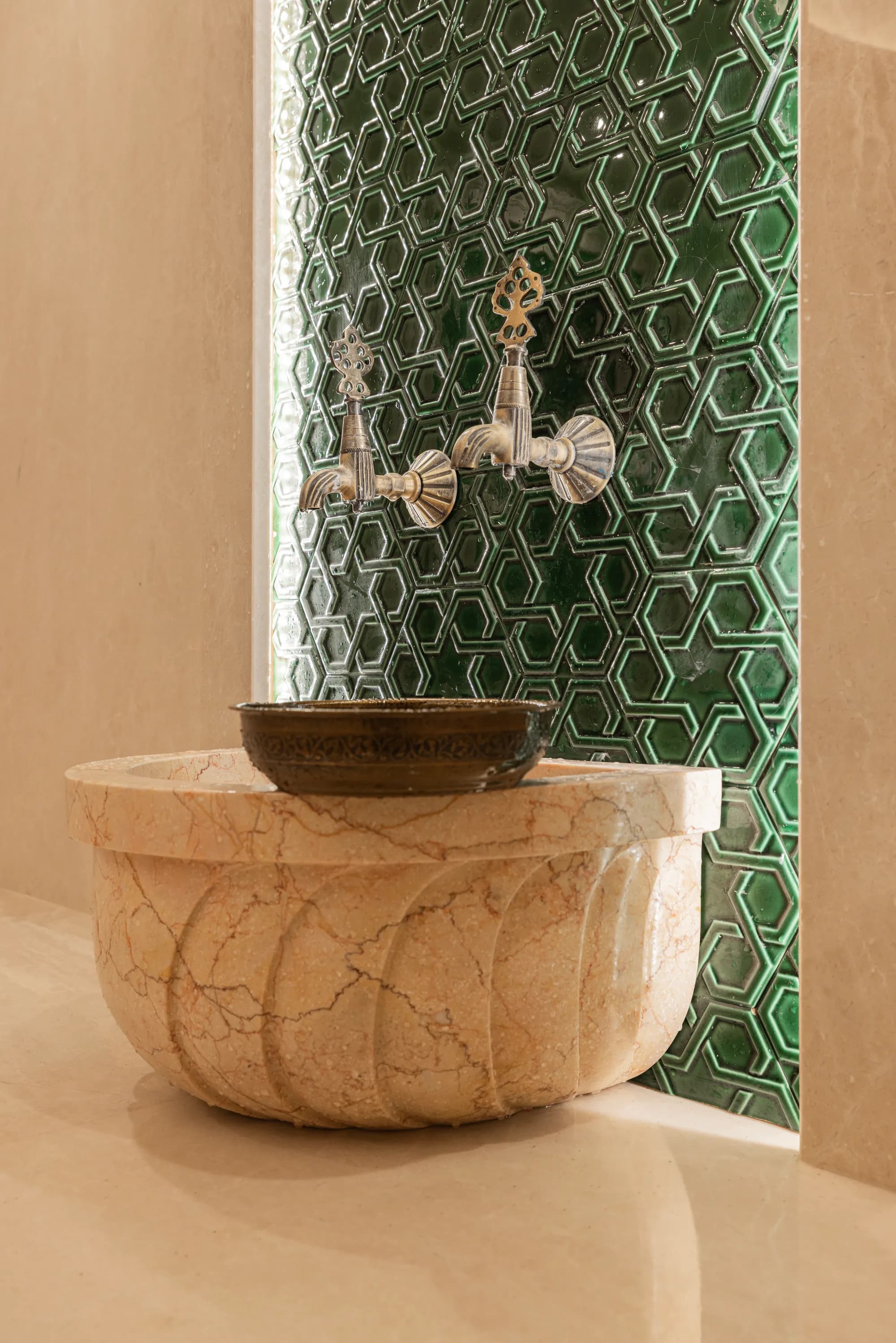 Stone basin against green hexagonal tiles, Şile, Istanbul (Turkey)
